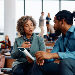 Attendees communicating on break at convention center.